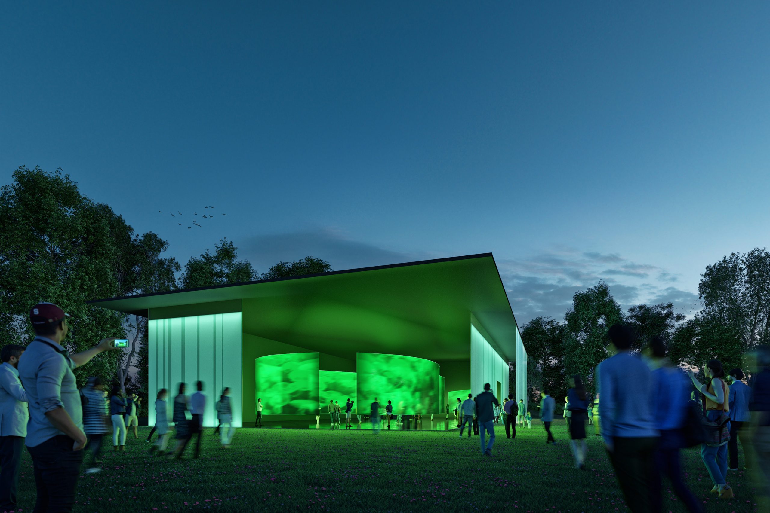 Der mobile Pavillon der STEIERMARK SCHAU (der Ersatz für die Landesausstellung)leuchtet grün in der Dämmerung.