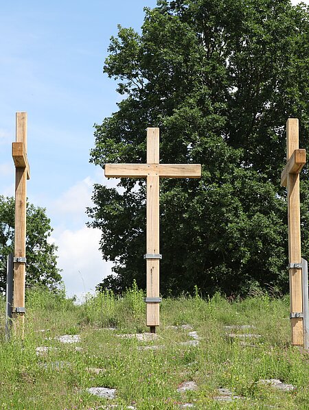 Drei große Kreuze stehen im Berggarten des Skulpturenparks. Die Möglichkeit einen Nagel einzuschlagen, macht das Kunstwerk interaktiv. 