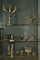In a display case there are various furnishings such as dishes, vases, candlesticks with the corresponding wick scissors. All items are made of horn and antler.