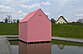 A small pink detached house stands by the water lily pond next to the Berggartencafé. Accessible via a footbridge, three projections can be viewed inside. 