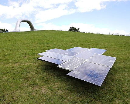 Eine Skulptur aus Photovoltaikpaneelen unterschiedlichen Alters. 
