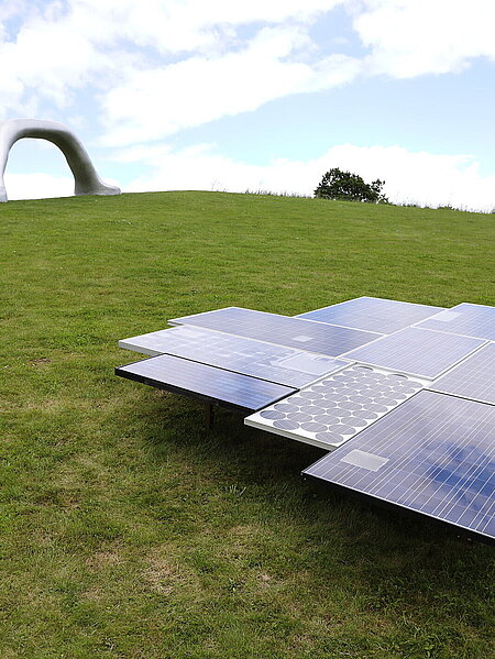 A sculpture made of photovoltaic peneels of various ages. 