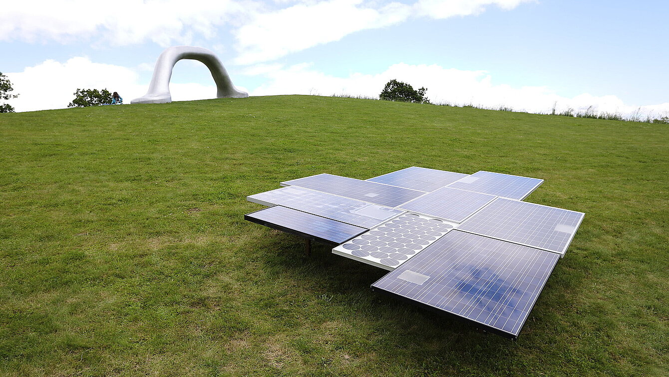 A sculpture made of photovoltaic peneels of various ages. 