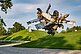 View of the sculpture "Airplane Parts & Hills" by Nancy Rubins from the edge of the path. A large sculpture made from airplane parts.