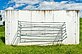 A vertical concrete slab with metal rods that form a basket.