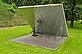 In the alpine garden of the sculpture park there is a diagonally rising concrete wall. It has small pieces of mirror on the underside. The environment is refracted by the sunlight in the shards. 