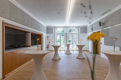 View of the foyer in the Heimatsaal with bar tables.