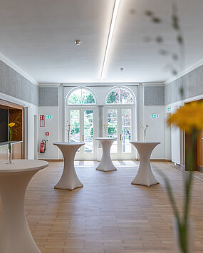 View of the foyer in the Heimatsaal with bar tables.