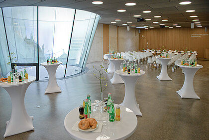 In the Auditorium, bar tables are set with drinks and jour pastries. 