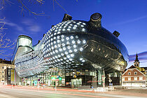 Ansicht des Kunsthaus Graz bei Nacht. Die BIX-Fassade leuchtet.