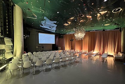 Space04 is set up for an awards ceremony with row seating, podium and screen.