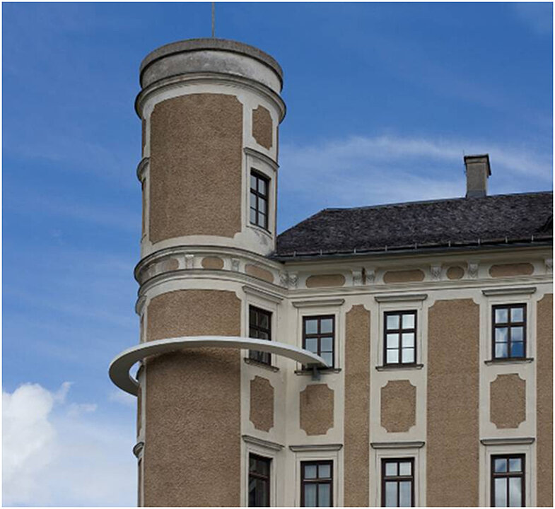 Ausstellungsansicht von einem Turm von Schloss Trautenfels. Um den Turm schwebt eine weiße halbkreisförmige Installation, die von einem Fenster zum nächsten führt. 