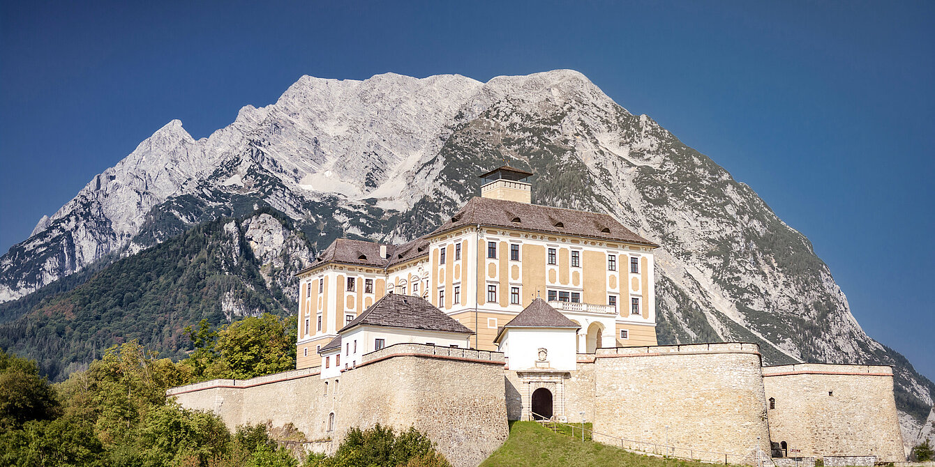 Trautenfels Castle with a blue sky in the background is Mount Grimming