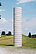 A "pillar" made of precast concrete elements in the entrance area of the sculpture park. The sculpture is deliberately not elaborately or beautifully designed. This keeps the attention on the material itself and allows a clear view of the world.