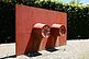 Two metal buckets with their hollow sides fixed to a red metal plate are the basic elements of this sculpture. In the object status of the world of objects, buckets normally stand on the floor. Wurm changes the form of presentation by opening up the base plate and changing the perspective from a floor sculpture to a wall sculpture.