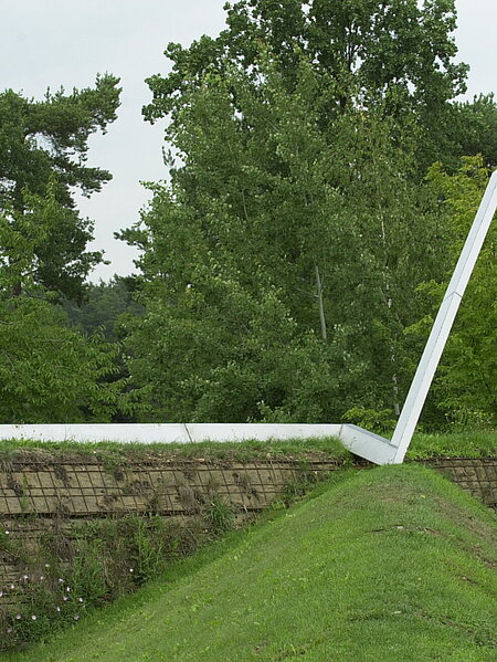 The sculpture "Now" is a double-angled steel rail at the top of a slope. It represents a timeline or a diagram of personal development and points to changes in direction.