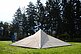 The sculpture in the shape of a stealth ship rests on the meadow. It is covered with beige-colored panels and cannot be detected by radar due to its shape.