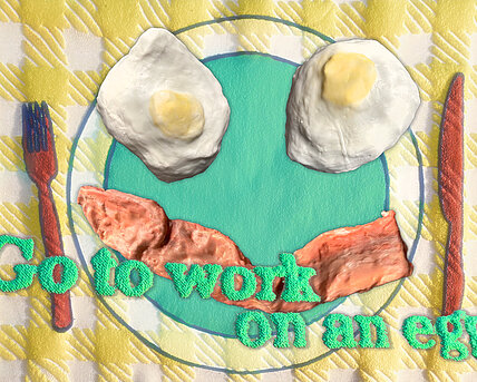 Green lettering reading "go to work on an egg" in front of sculptures of two fried eggs and a baconstrip lying on a fabric plate. Next to it, a fork and a knife made out of fabric.
